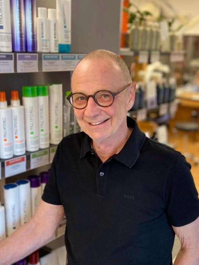 Ronald „Ronny“ Weinberger, Inhaber, im Salon vor der Paul-Mitchell-Pflegewand